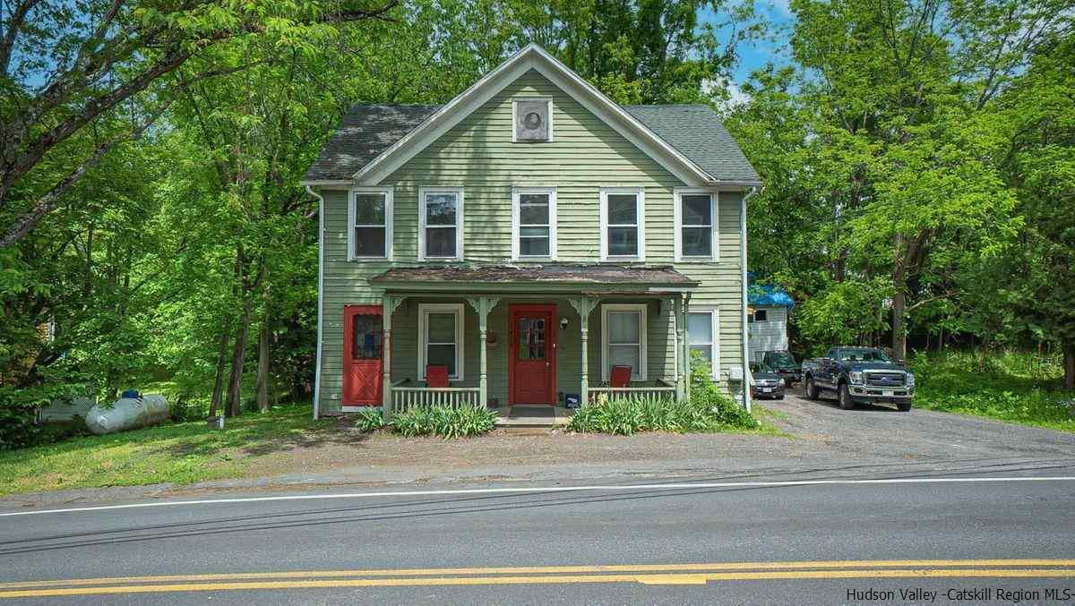 3418 Cooper Street Stone Ridge, NY 12484 - Photo 3 of 34 a front view of a house with a garden