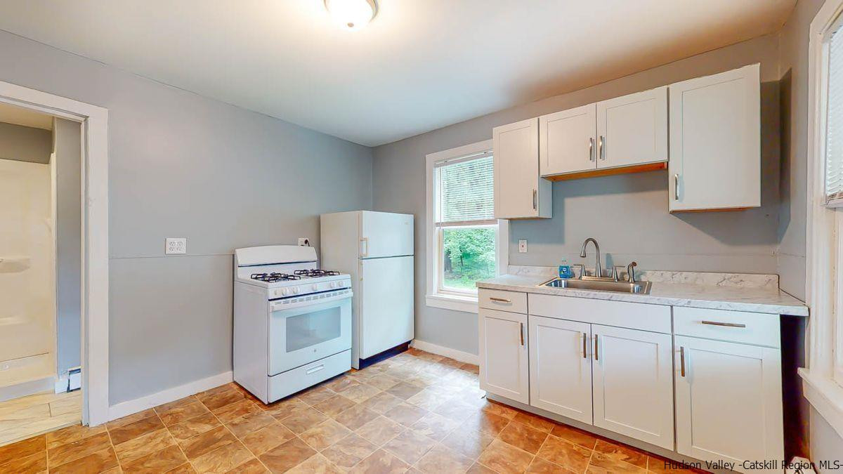 3418 Cooper Street Stone Ridge, NY 12484 - Photo 4 of 34 a kitchen with a stove top oven sink and cabinets