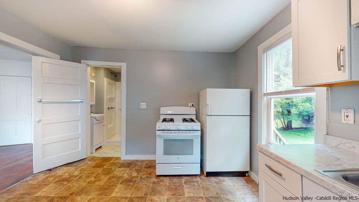 3418 Cooper Street Stone Ridge, NY 12484 - Photo 5 of 34 a kitchen that has a stove and a refrigerator