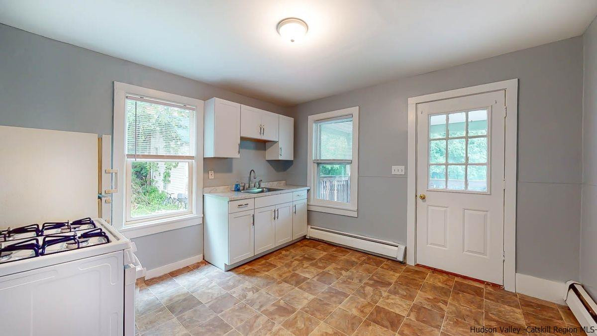 3418 Cooper Street Stone Ridge, NY 12484 - Photo 6 of 34 a kitchen with stainless steel appliances granite countertop a stove a sink and a refrigerator