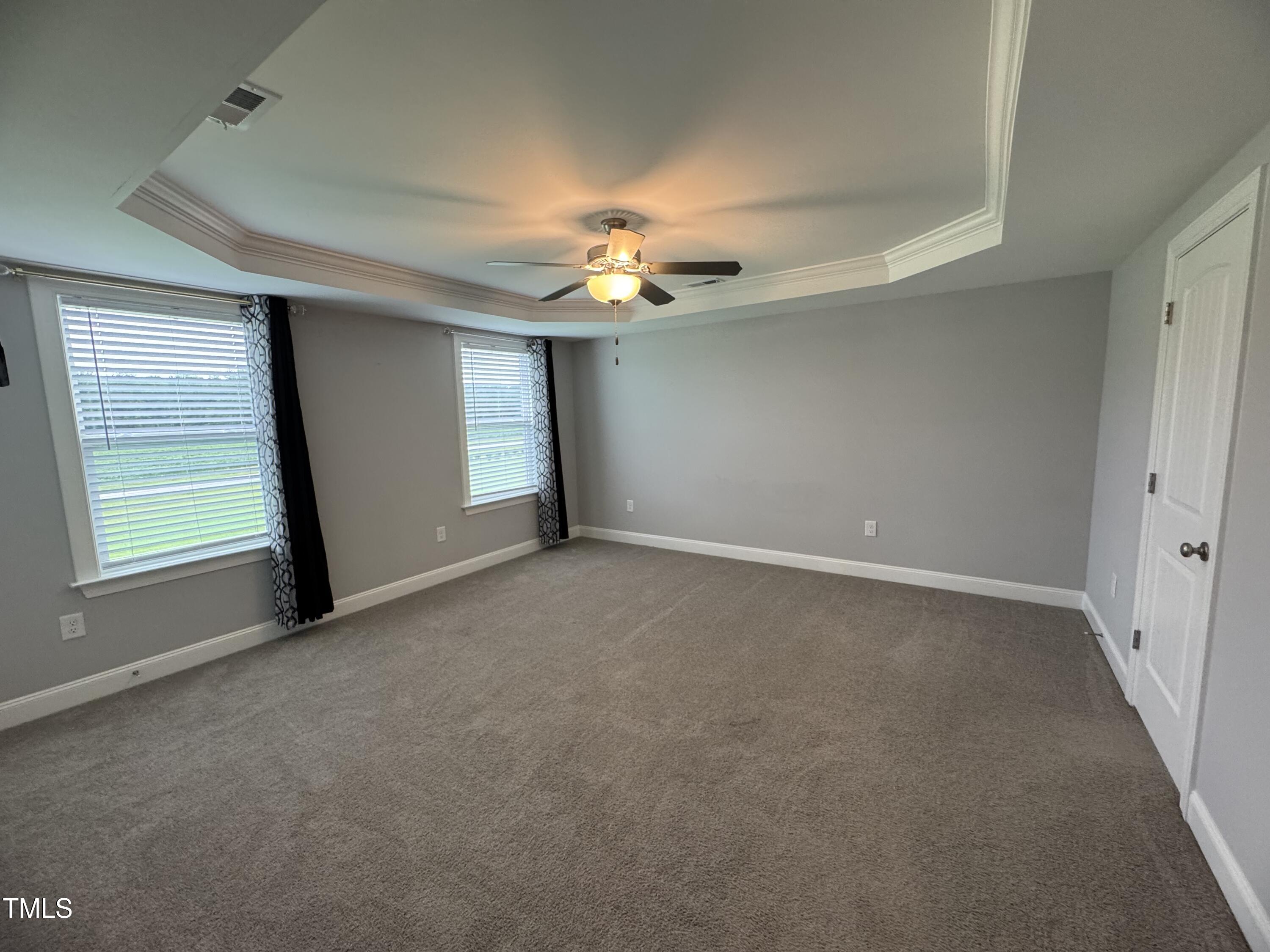 52 Shining Pearl Court Smithfield, NC 27577 - Photo 12 of 23 en empty room with windows and chandelier fan