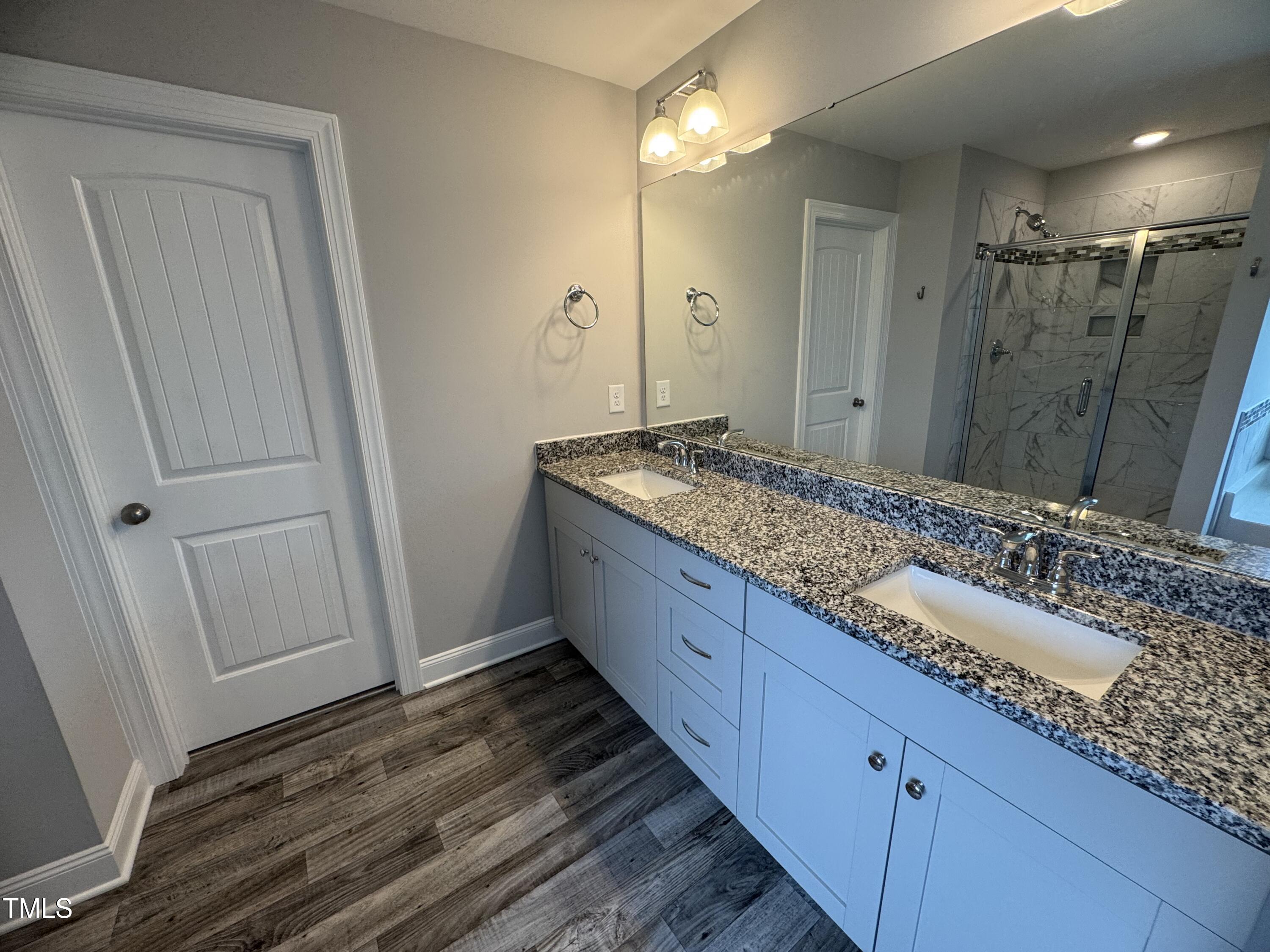 52 Shining Pearl Court Smithfield, NC 27577 - Photo 13 of 23 a bathroom with a granite countertop sink and a mirror