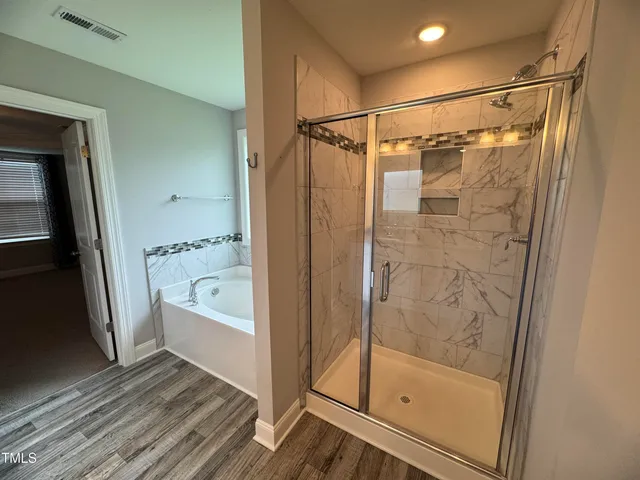 a bathroom with a bathtub and a shower