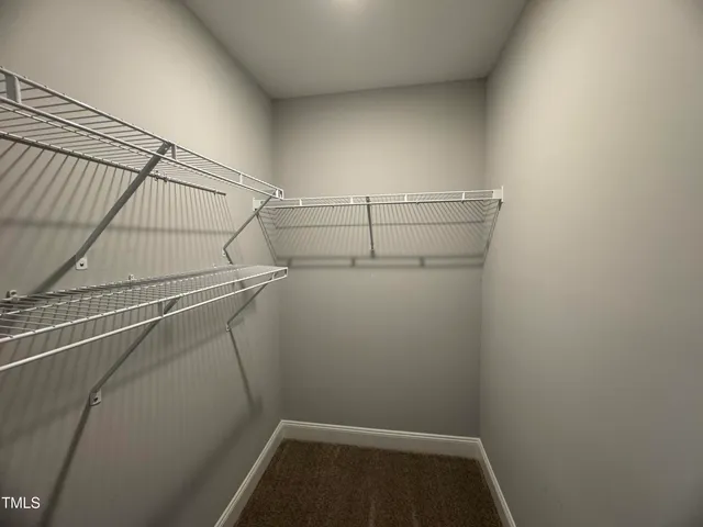 a view of storage and utility room with racks on the wall