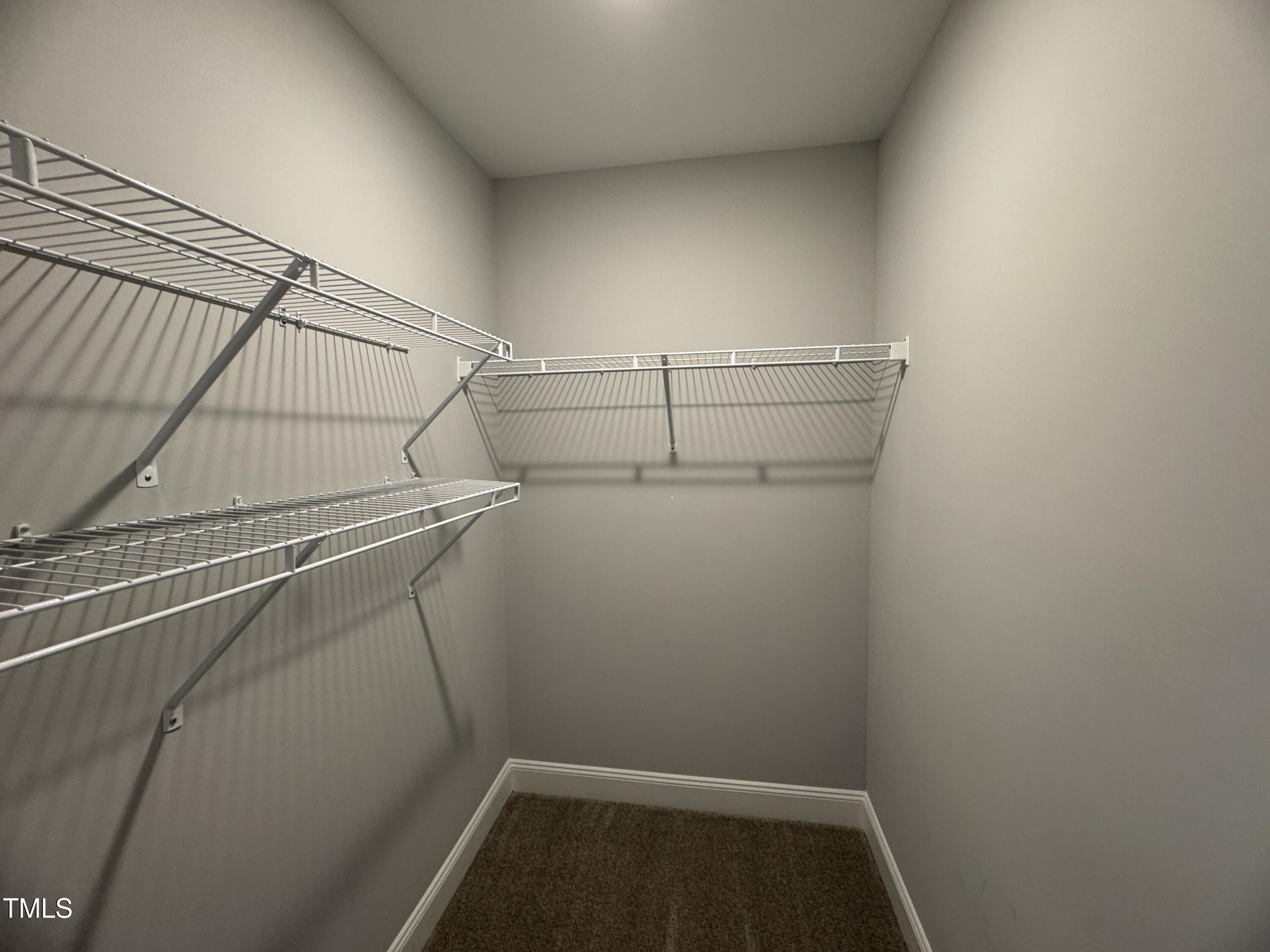 52 Shining Pearl Court Smithfield, NC 27577 - Photo 16 of 23 a view of storage and utility room with racks on the wall