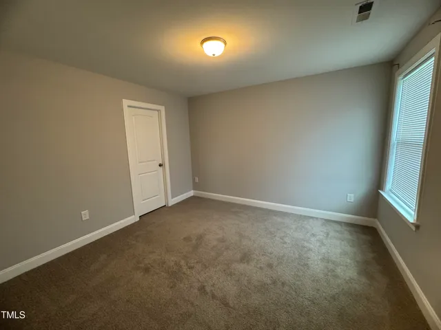 an empty room with a bench