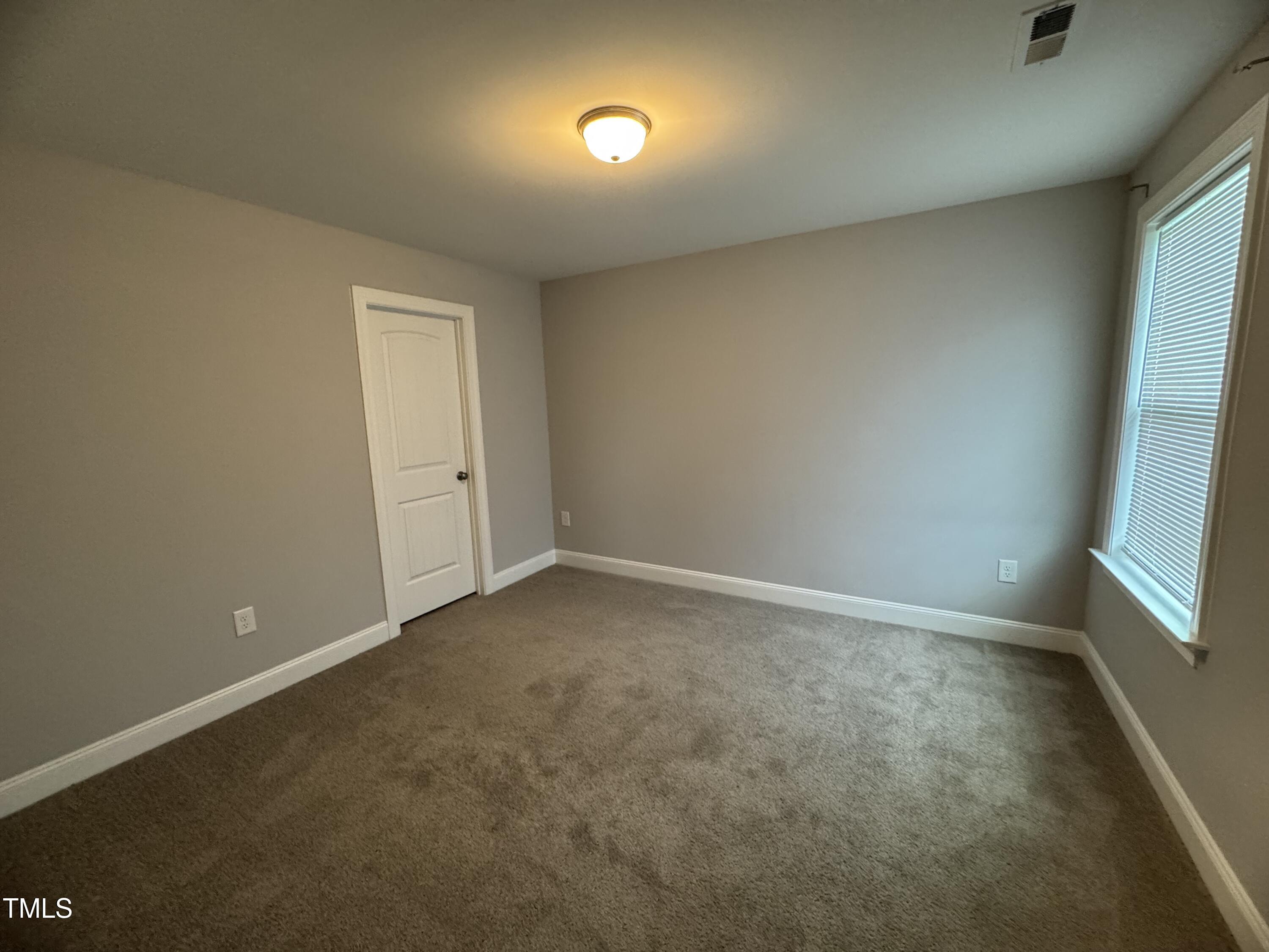52 Shining Pearl Court Smithfield, NC 27577 - Photo 19 of 23 an empty room with a bench