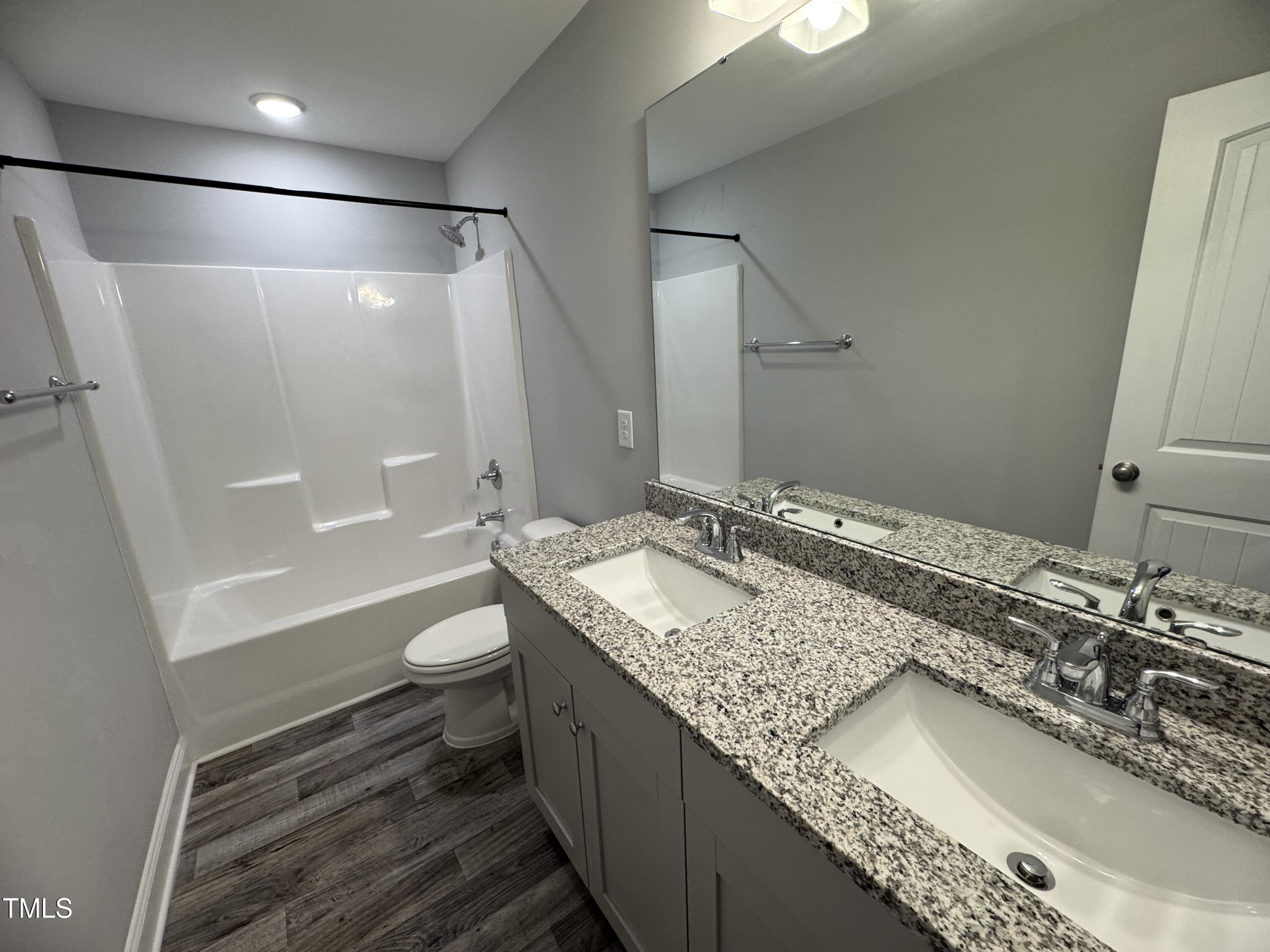 52 Shining Pearl Court Smithfield, NC 27577 - Photo 20 of 23 a bathroom with a granite countertop sink toilet and shower