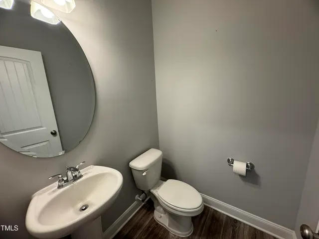 a bathroom with a sink mirror and toilet
