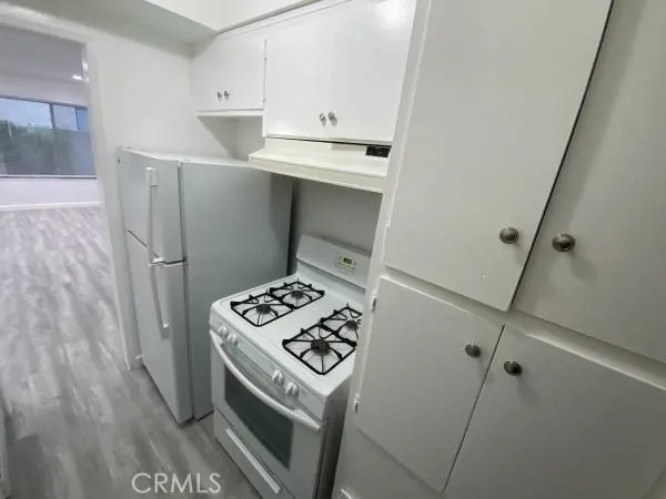 a kitchen with a stove and a refrigerator