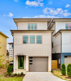 a front view of a house with garage