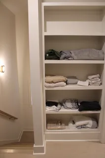 a shelf with cup and plates