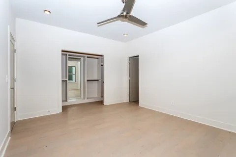 a view of walk in closet with empty racks