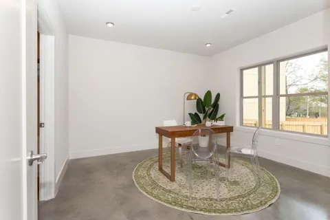 a view of a dining room with furniture window and outside view