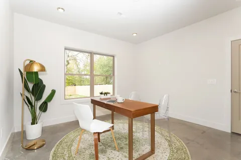 a dining room with furniture and wooden floor
