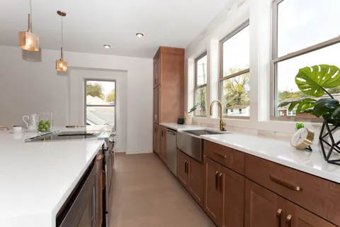 a kitchen with a sink and windows