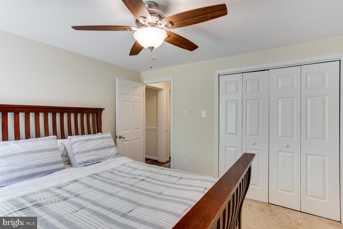 1260 Coster Road Lusby, MD 20657 - Photo 28 of 46 a bedroom with a bed and a chandelier