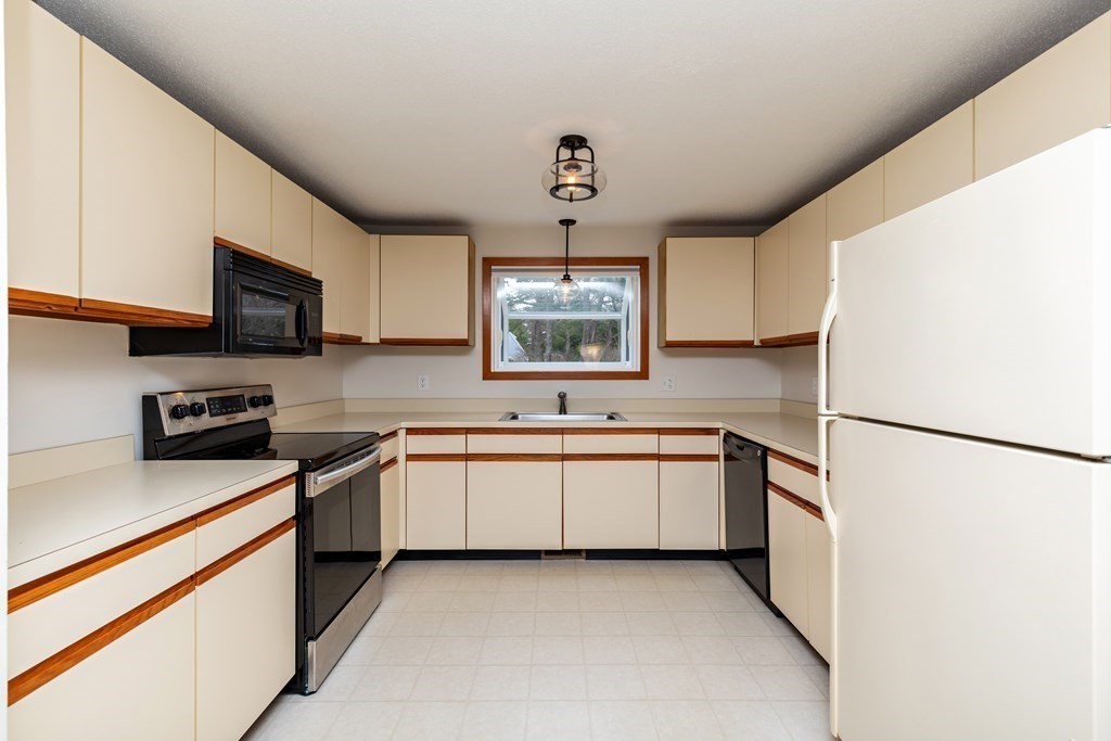 140 Shellback Way, Unit 140 Mashpee, MA 02649 - Photo 11 of 29 a kitchen with stainless steel appliances a refrigerator sink and microwave