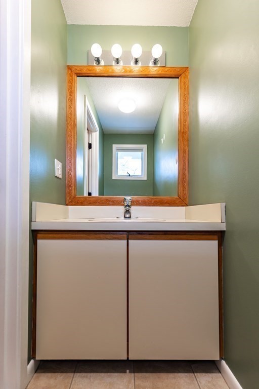 140 Shellback Way, Unit 140 Mashpee, MA 02649 - Photo 14 of 29 a bathroom with a sink and a mirror