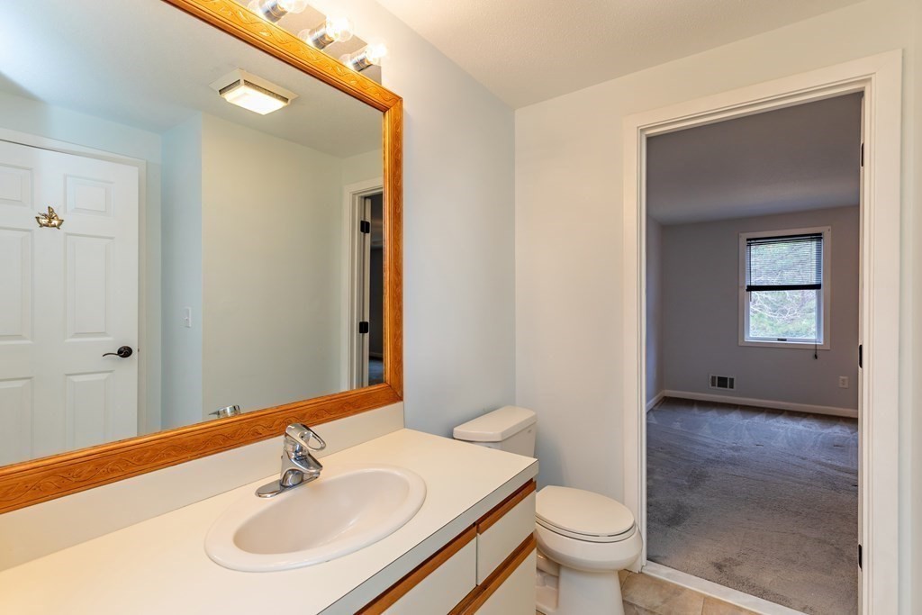 140 Shellback Way, Unit 140 Mashpee, MA 02649 - Photo 16 of 29 a bathroom with a sink and a mirror