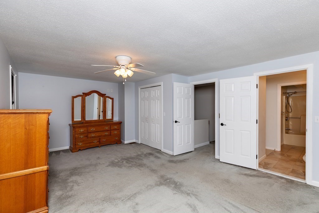 140 Shellback Way, Unit 140 Mashpee, MA 02649 - Photo 18 of 29 a room with a bed and a chandelier