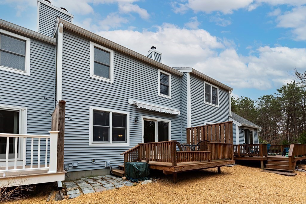 140 Shellback Way, Unit 140 Mashpee, MA 02649 - Photo 28 of 29 a view of a house with a yard