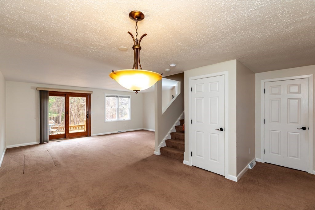 140 Shellback Way, Unit 140 Mashpee, MA 02649 - Photo 3 of 29 a view of a room with a chandelier