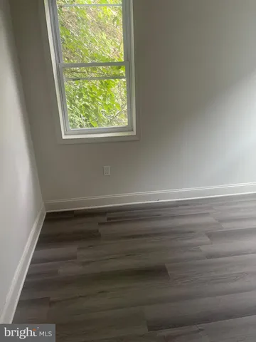 a view of a room with wooden floor and window