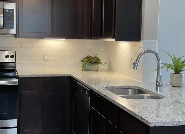 a kitchen with a sink and cabinets