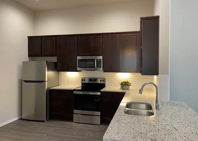 a kitchen with a sink cabinets and stainless steel appliances