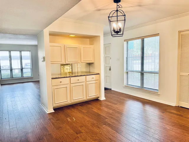 a view of a room with wooden floor cabinet and windows