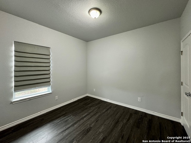 1285 Live Oak Drive Spring Branch, TX 78070 - Photo 16 of 17 a view of an empty room with wooden floor and a window
