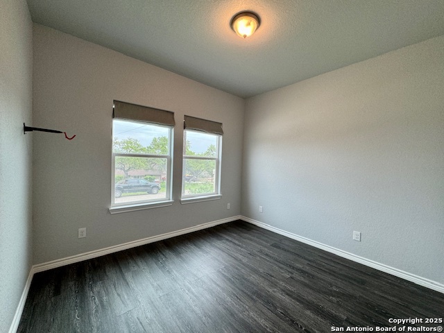 1285 Live Oak Drive Spring Branch, TX 78070 - Photo 17 of 17 an empty room with wooden floor and windows