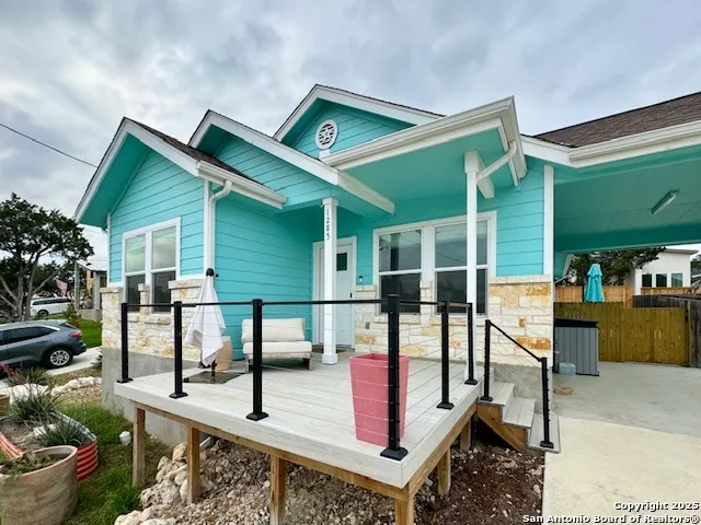 a front view of a house with outdoor seating and stairs