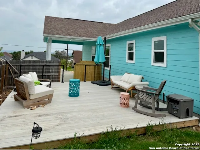 a view of a patio with table and chairs and potted plants