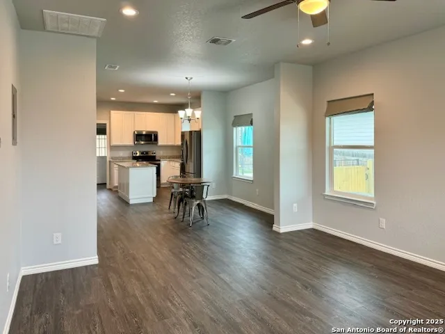 a view of a kitchen with dining table and chairs