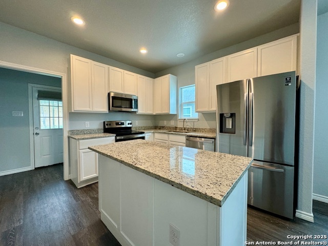 1285 Live Oak Drive Spring Branch, TX 78070 - Photo 10 of 17 a kitchen with granite countertop a refrigerator a sink a stove a microwave and island