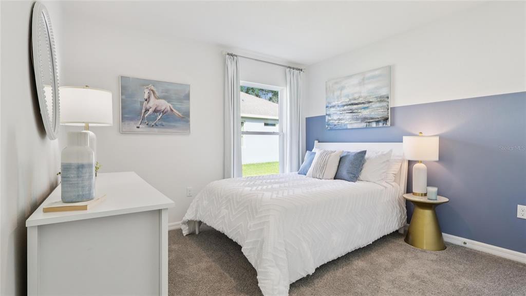 11 Locust Cir Lane Ocala, FL 34472 - Photo 18 of 20 a bedroom with a bed and a table