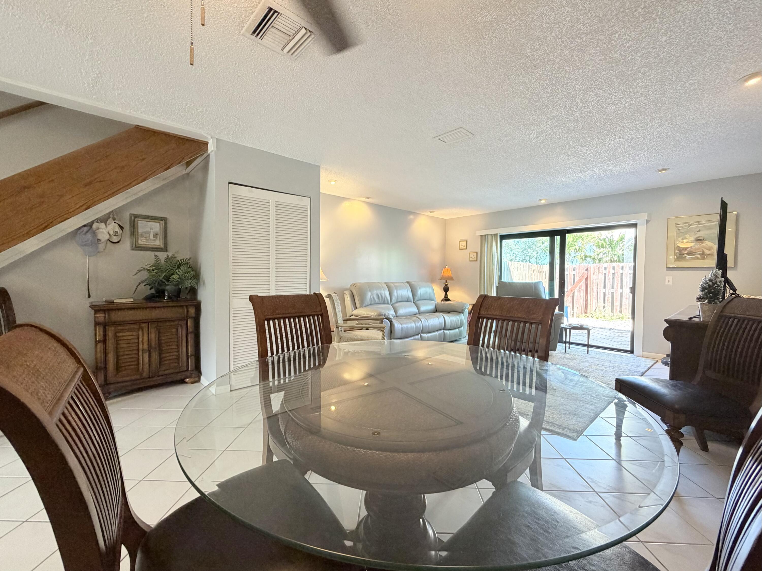 4235 North Hwy A1A, Unit 14 Hutchinson Island, FL 34949 - Photo 14 of 36 a living room with couches chairs and a dining table with garden view