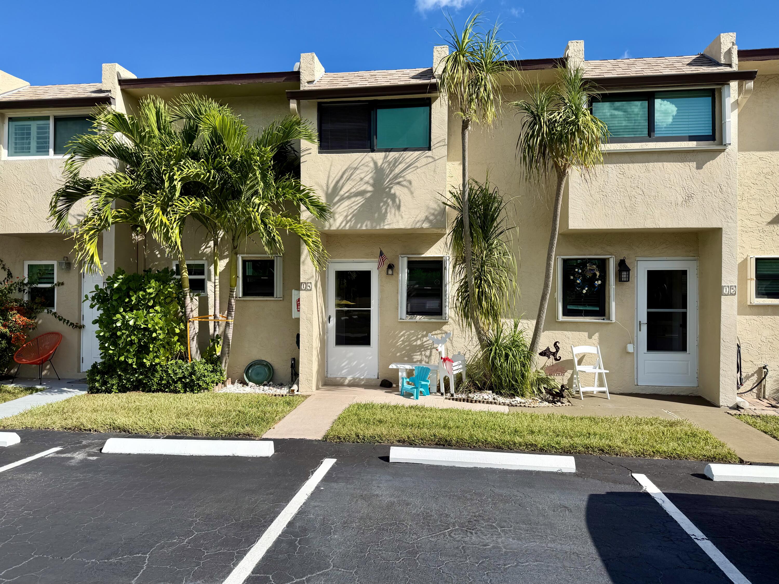 4235 North Hwy A1A, Unit 14 Hutchinson Island, FL 34949 - Photo 2 of 36 a front view of a house with a yard