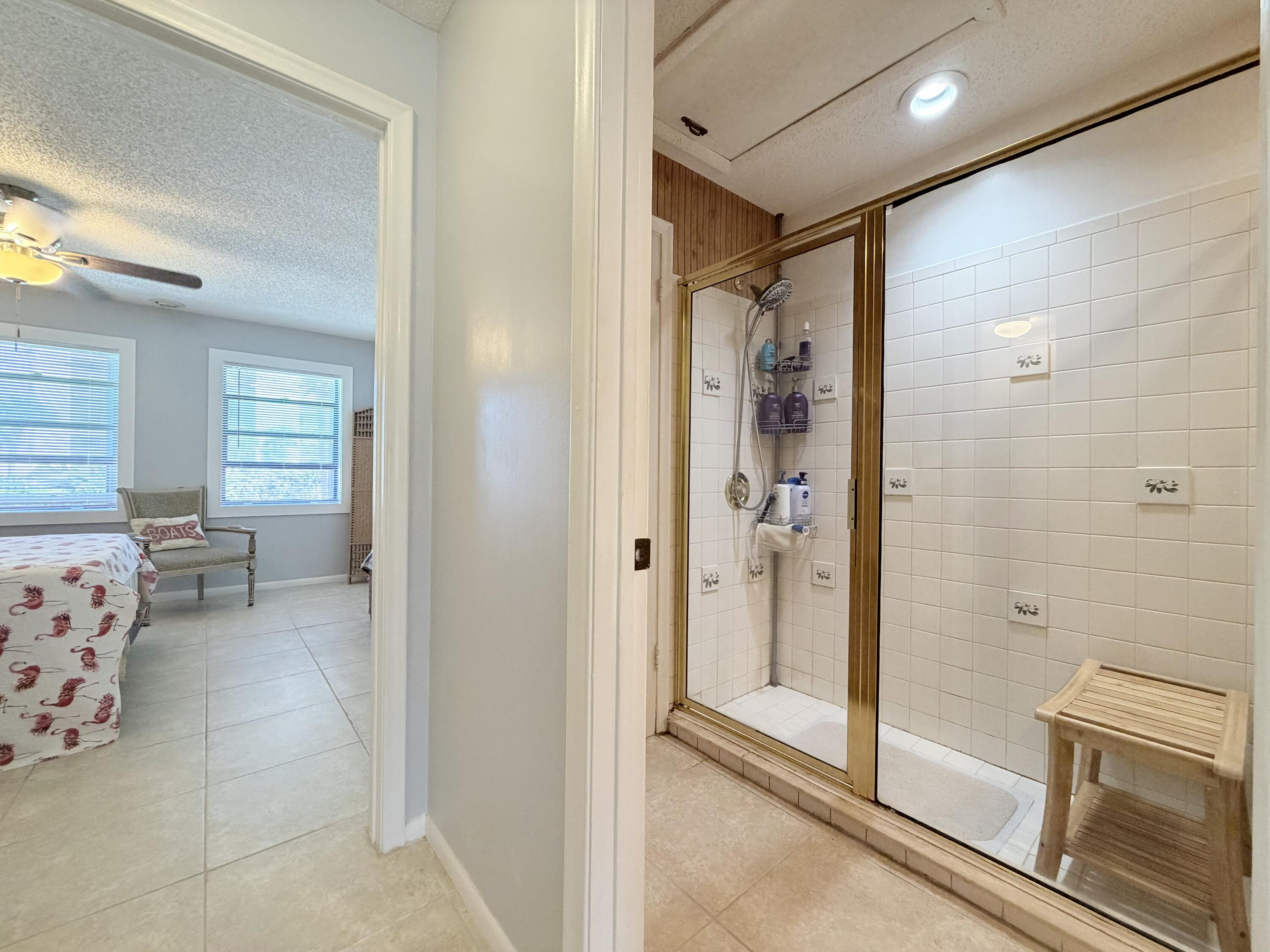 4235 North Hwy A1A, Unit 14 Hutchinson Island, FL 34949 - Photo 21 of 36 a bathroom with a bathtub and a shower