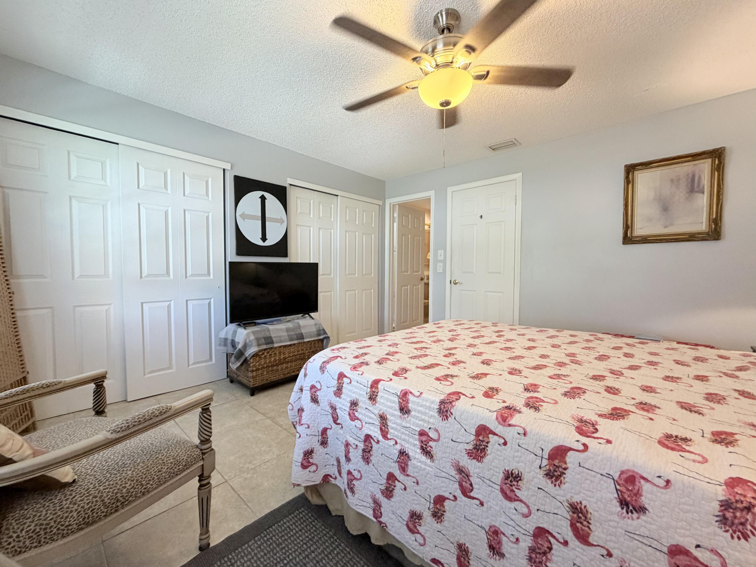 4235 North Hwy A1A, Unit 14 Hutchinson Island, FL 34949 - Photo 23 of 36 a bedroom with a bed and a tv