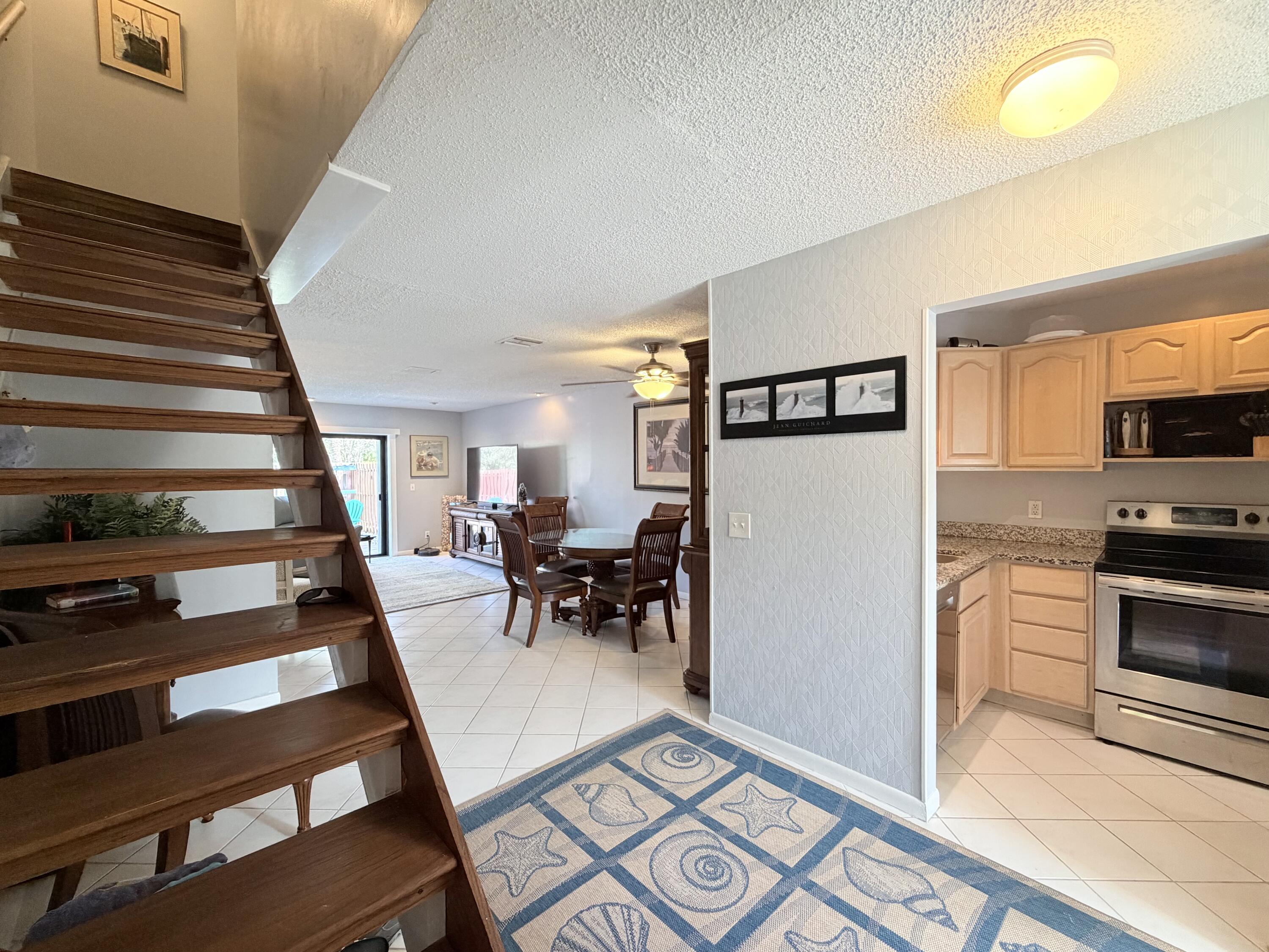 4235 North Hwy A1A, Unit 14 Hutchinson Island, FL 34949 - Photo 4 of 36 a living room with furniture and a flat screen tv
