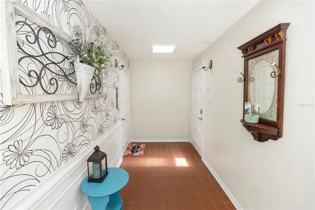 an empty room with windows and fireplace