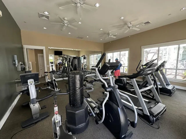a view of a patio with table and chairs potted plants with wooden floor and fence