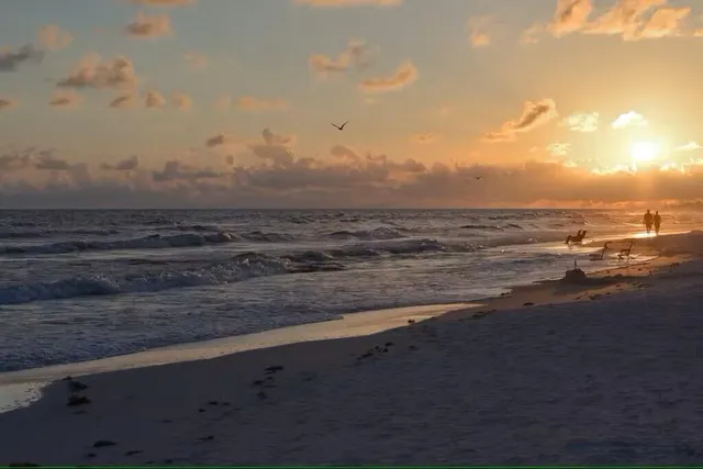 a kitchen with a table chairs stove and kitchen view