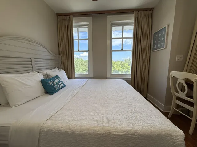 a bed sitting in a bedroom next to a window