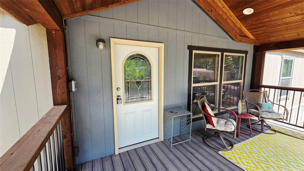 45 Bravo Road Pottsboro, TX 75076 - Photo 2 of 40 Covered porch with wood-finish ceiling, gray siding, and composite decking