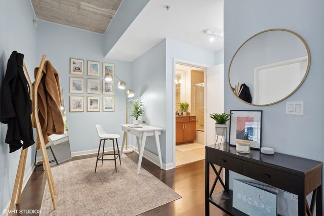 a work room with furniture and a wooden floor
