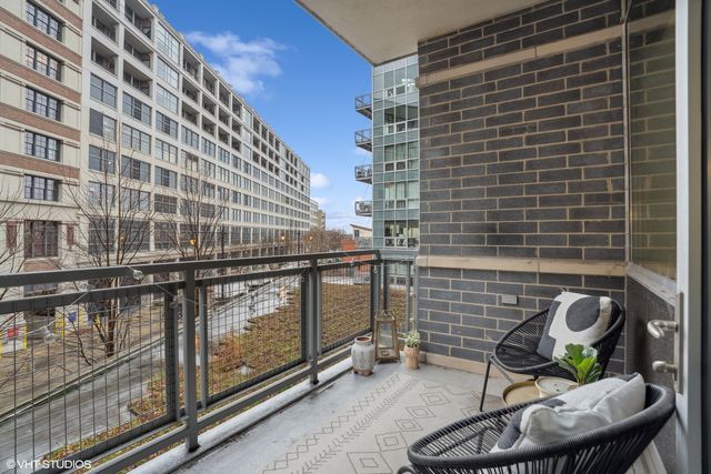 a balcony with table and chairs